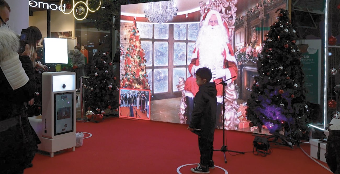 Un enfant entrain de se prendre en photo avec le Père Noël en direct de Laponie